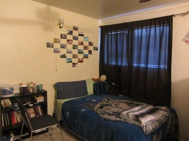 2513 47th Street Lubbock, TX 79413 - Photo 9 of 10 a bed sitting in a bedroom next to a window and a chair
