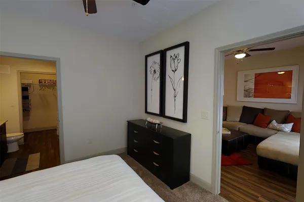 a bedroom with a bed and wooden floor