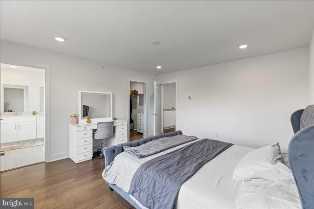 a bedroom with a bed and a view of kitchen
