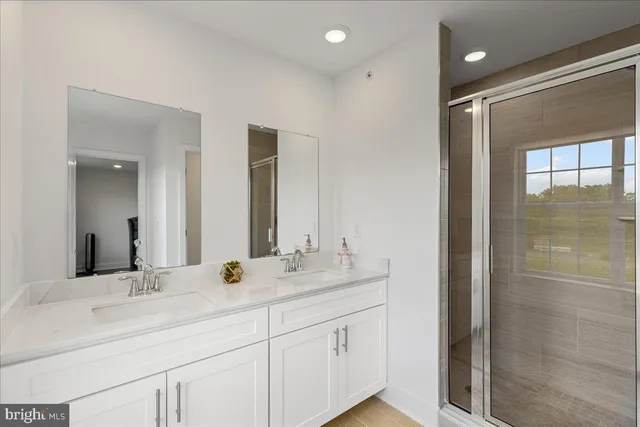 a bathroom with double sink and a mirror