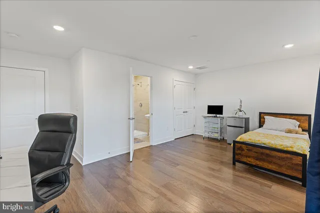 a bedroom with bed and chair