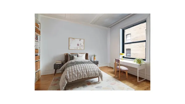 a living room with a bed furniture and a window