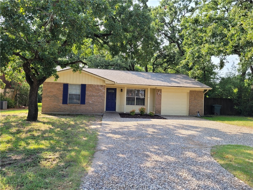 a house that has a tree in front of it