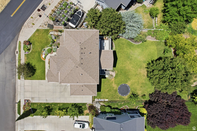 1263 East 1200th South Springville, UT 84663 - Photo 60 of 60 Aerial perspective showcasing a property with a spacious front yard, extensive paved driveway, and a multi-level roofline