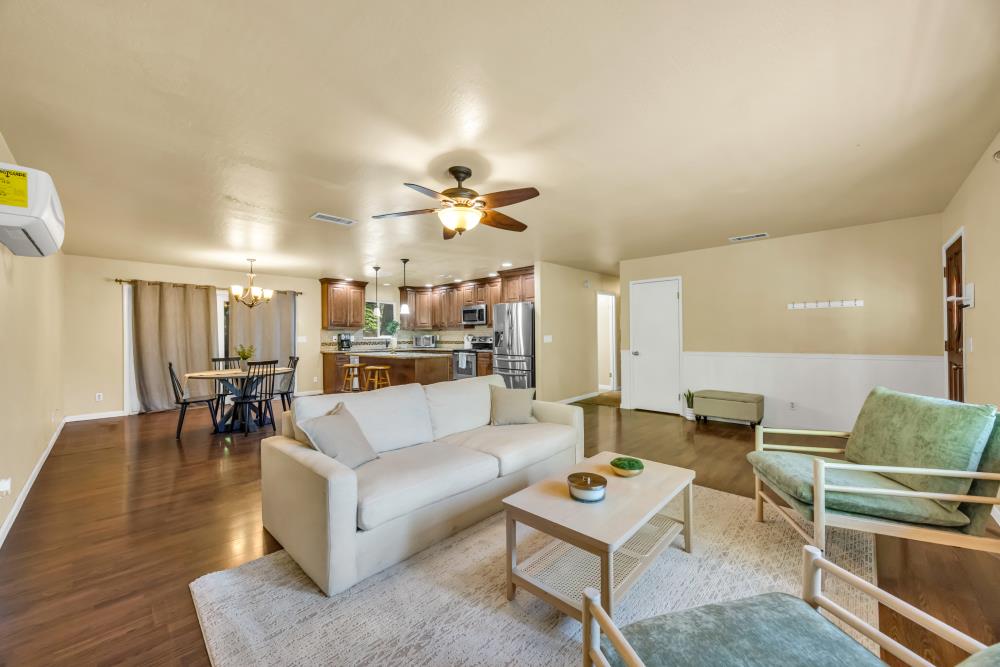 a living room with furniture and view of kitchen