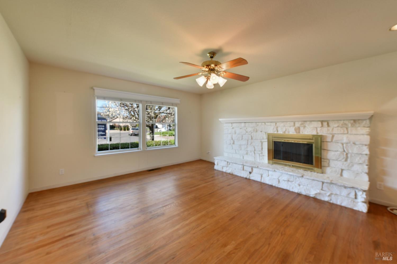 135 Fulton Place Windsor, CA 95492 - Photo 18 of 41 an empty room with windows and fireplace