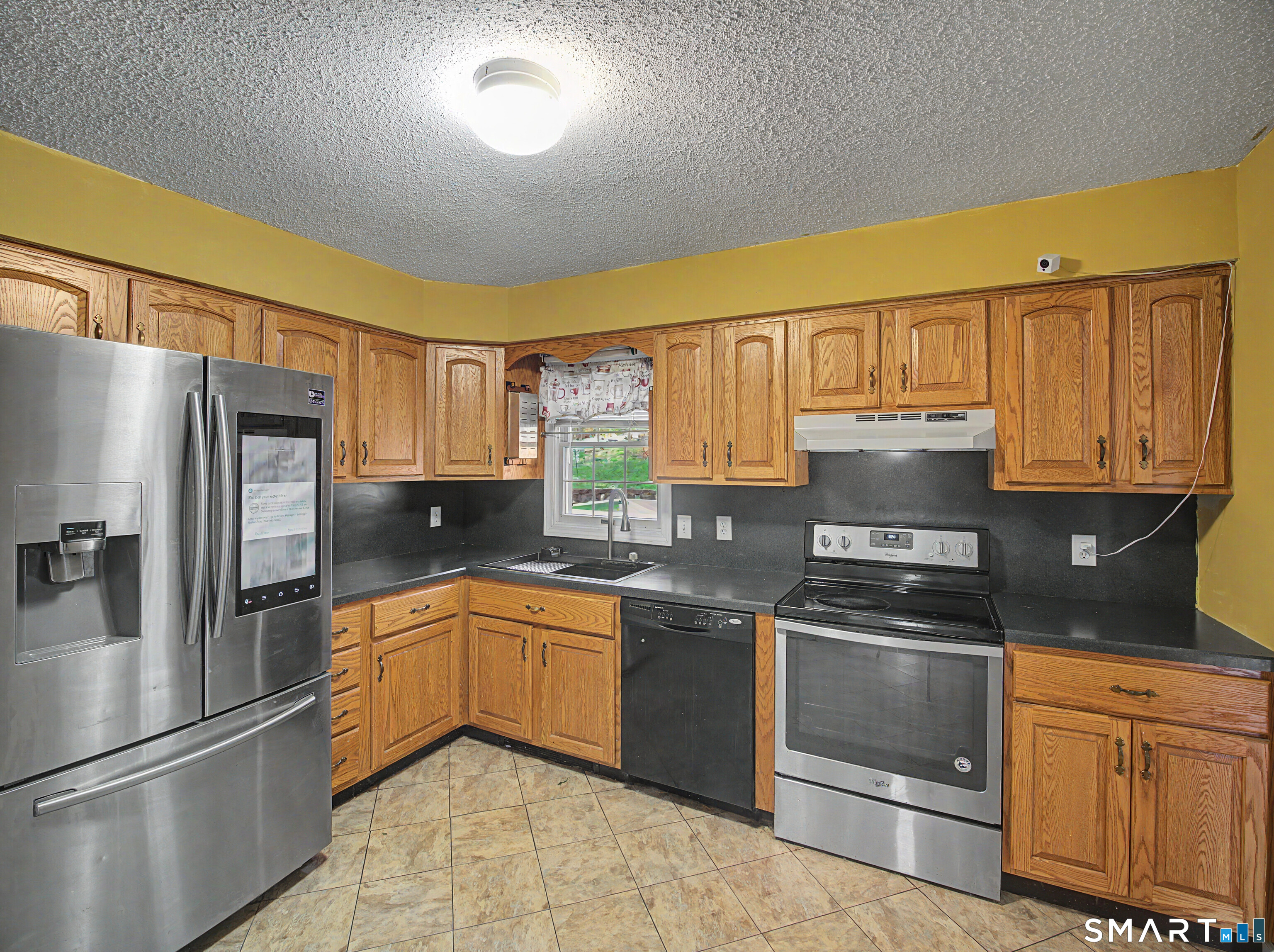 134 Roulin Street Torrington, CT 06790 - Photo 7 of 27 a kitchen with stainless steel appliances granite countertop a stove a sink dishwasher a refrigerator and cabinets with wooden floor