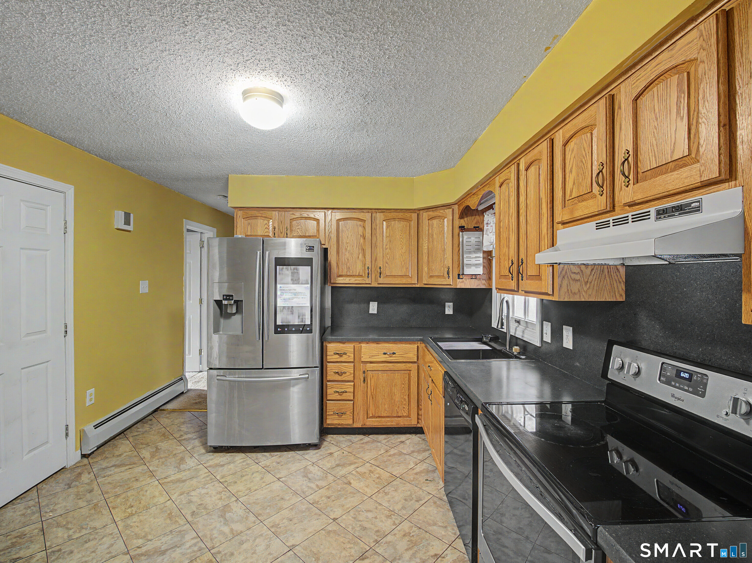 134 Roulin Street Torrington, CT 06790 - Photo 8 of 27 a kitchen with stainless steel appliances granite countertop a refrigerator a stove and a sink