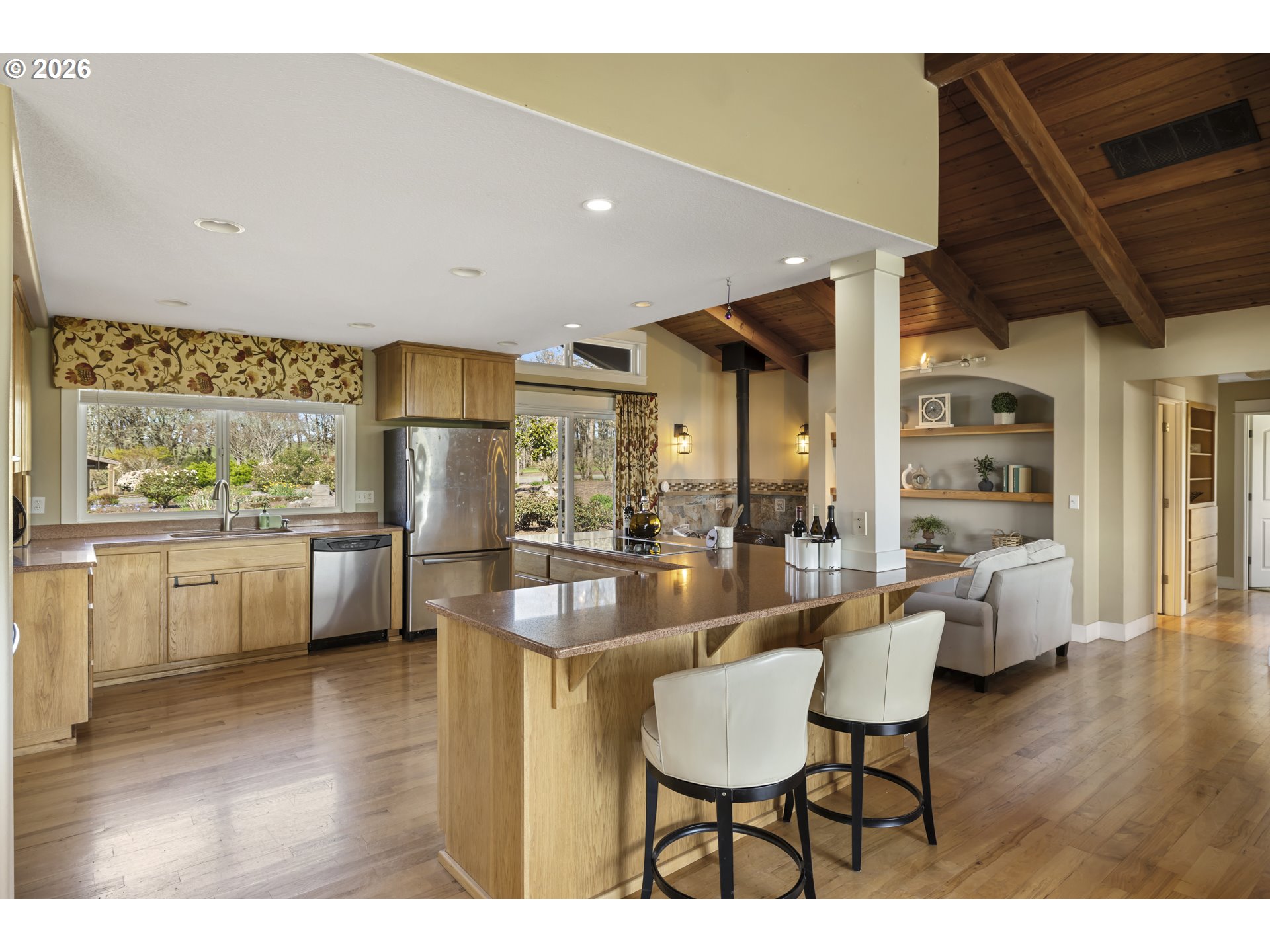 17795 Northeast Laughlin Road Yamhill, OR 97148 - Photo 13 of 48 a dining hall with stainless steel appliances a dining table wooden floor and a large window