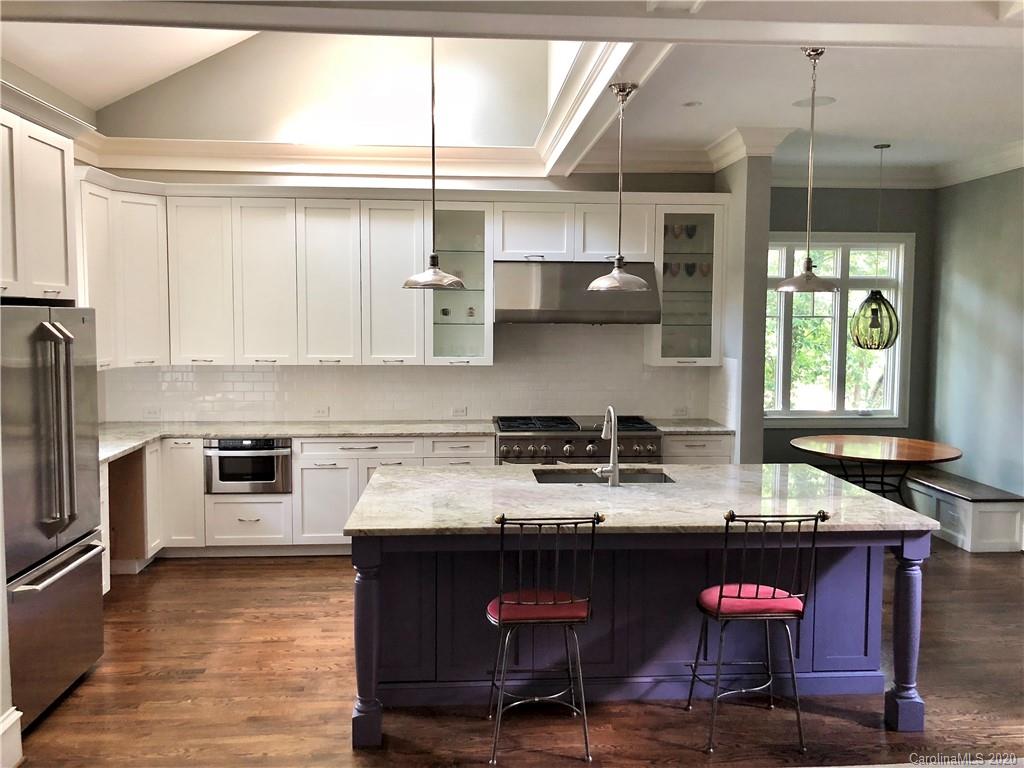 1438 Lilac Road Charlotte, NC 28209 - Photo 3 of 24 a kitchen with stainless steel appliances granite countertop a sink stove and refrigerator