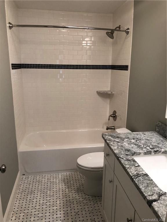 1438 Lilac Road Charlotte, NC 28209 - Photo 22 of 24 a bathroom with a granite countertop sink toilet and shower
