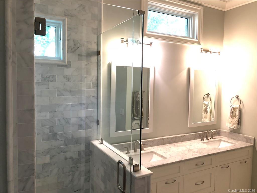 1438 Lilac Road Charlotte, NC 28209 - Photo 8 of 24 a bathroom with a granite countertop sink and a mirror