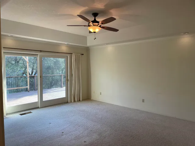 a view of a livingroom with a ceiling fan and window