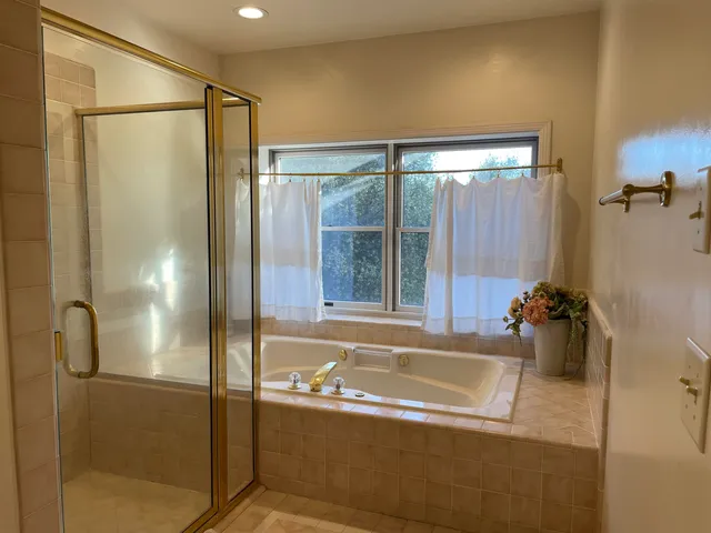 a bathroom with a tub and shower
