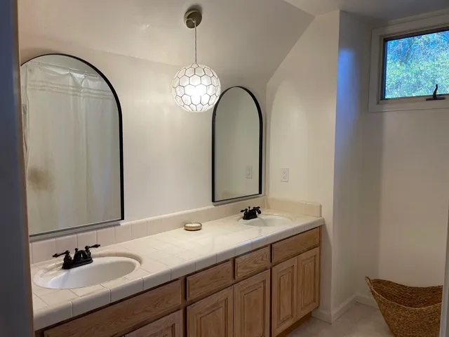 a bathroom with a double vanity sink and a mirror