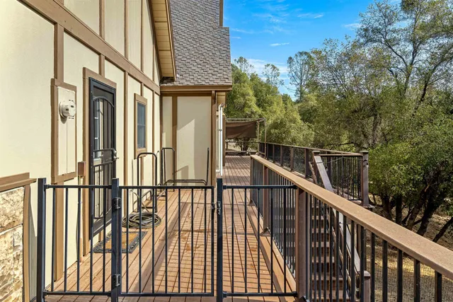 a view of a balcony with wooden floor and fence