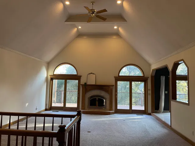a view of a livingroom with a fireplace and window