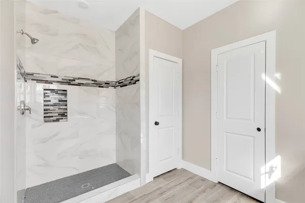 a bathroom with a glass shower door