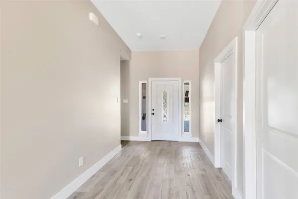 a view of a hallway with wooden floor