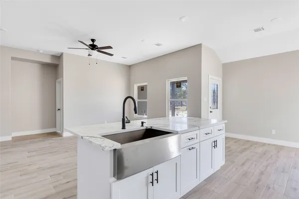 a kitchen with stainless steel appliances kitchen island a sink a stove and cabinets
