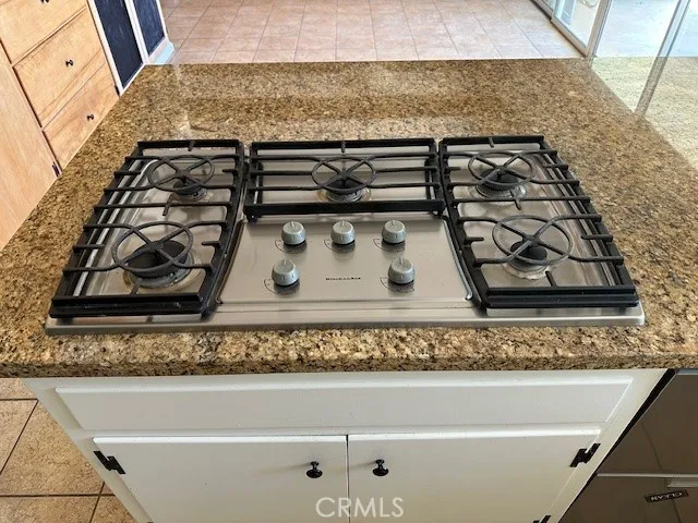 a kitchen with cabinets and stainless steel appliances