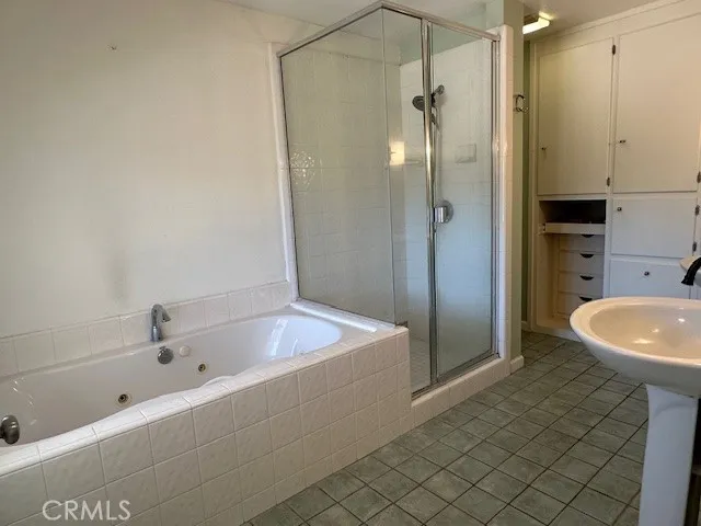 a bathroom with a sink a mirror and shower