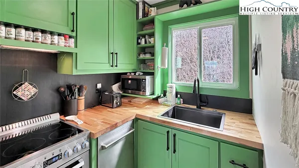 a kitchen with a sink and a stove top oven