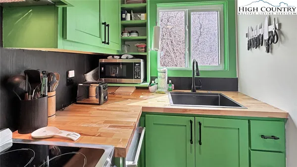 a kitchen with a sink cabinets and outdoor seating