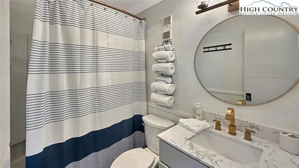 a bathroom with a sink a toilet and mirror