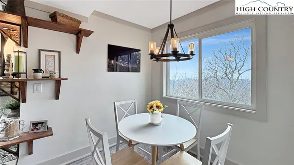 a living room with furniture a window and a table