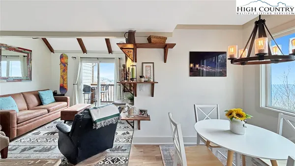 a living room with furniture a rug and a fireplace