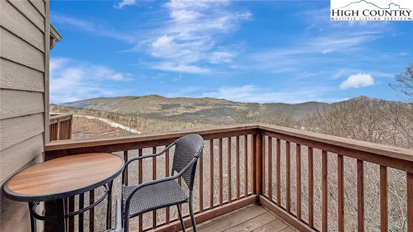 a view of a dry yard with mountains in the background