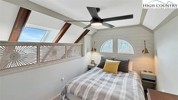 a living room with furniture a fireplace and wooden floor