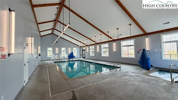 a view of a tennis ground with large trees