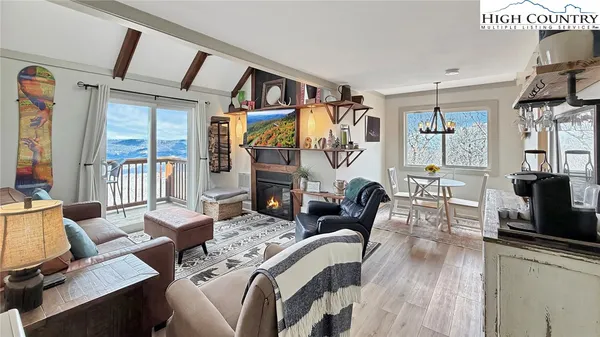 a living room with fireplace furniture and a flat screen tv