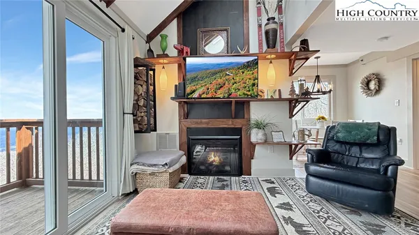 a living room with furniture a rug and a fireplace