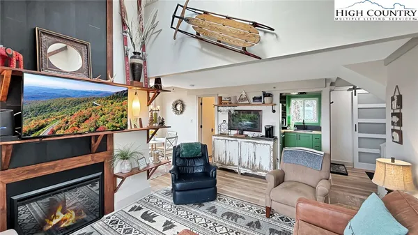 a living room with furniture a rug and a fireplace