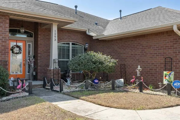 a view of a house with a patio and a yard
