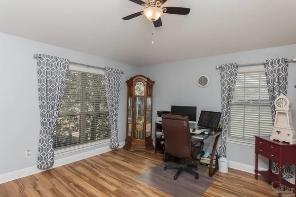 a view of a workspace with furniture and a window