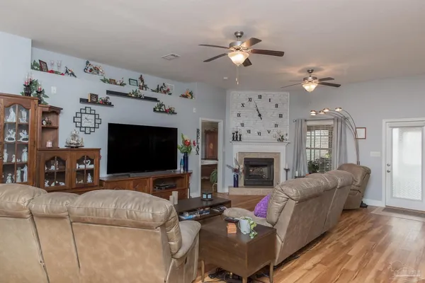 a living room with furniture a flat screen tv and a fireplace