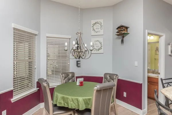 a view of a dining room with furniture and a window