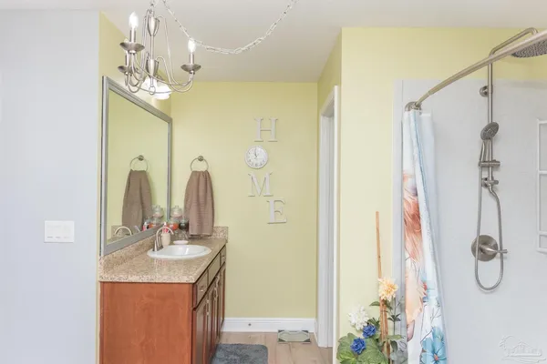 a bathroom with a granite countertop shower sink and mirror