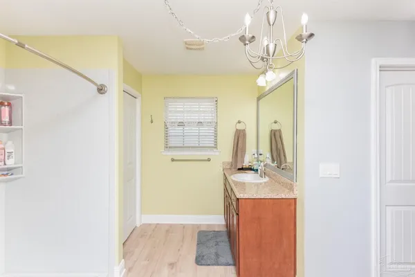 a bathroom with a sink a mirror and a shower