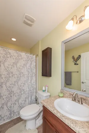 a view of a hallway and a livingroom with furniture