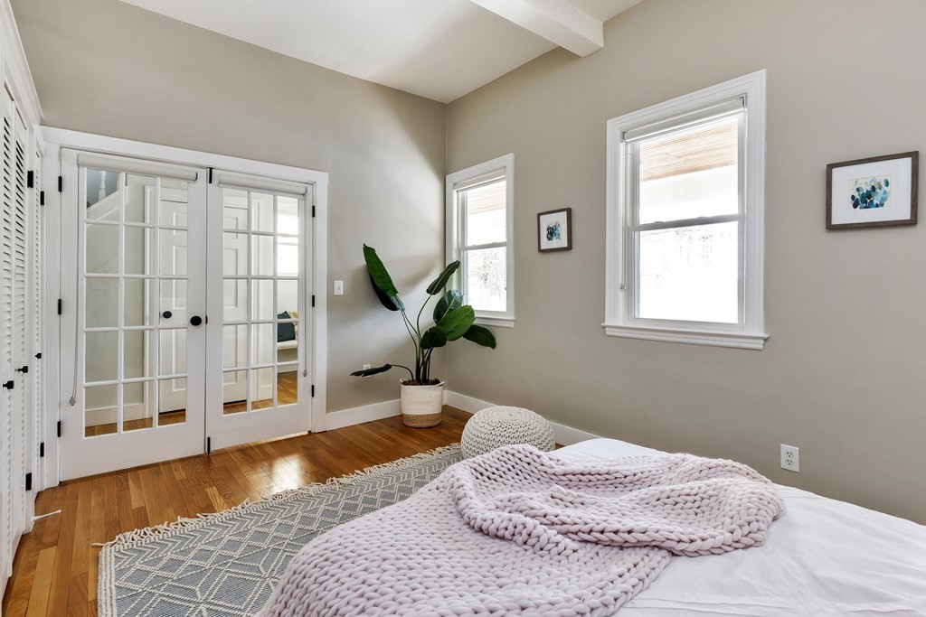 24 Adams Street, Unit 5 Somerville, MA 02145 - Photo 11 of 28 a bedroom with a bed and a window