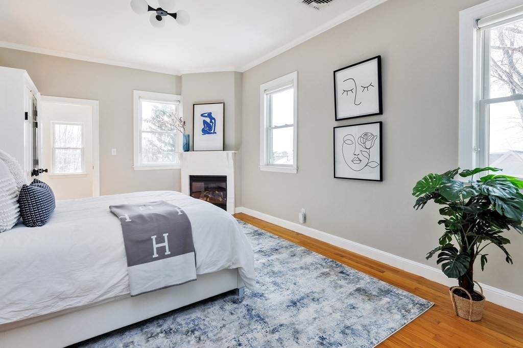 24 Adams Street, Unit 5 Somerville, MA 02145 - Photo 17 of 28 a bedroom with a bed table and a window