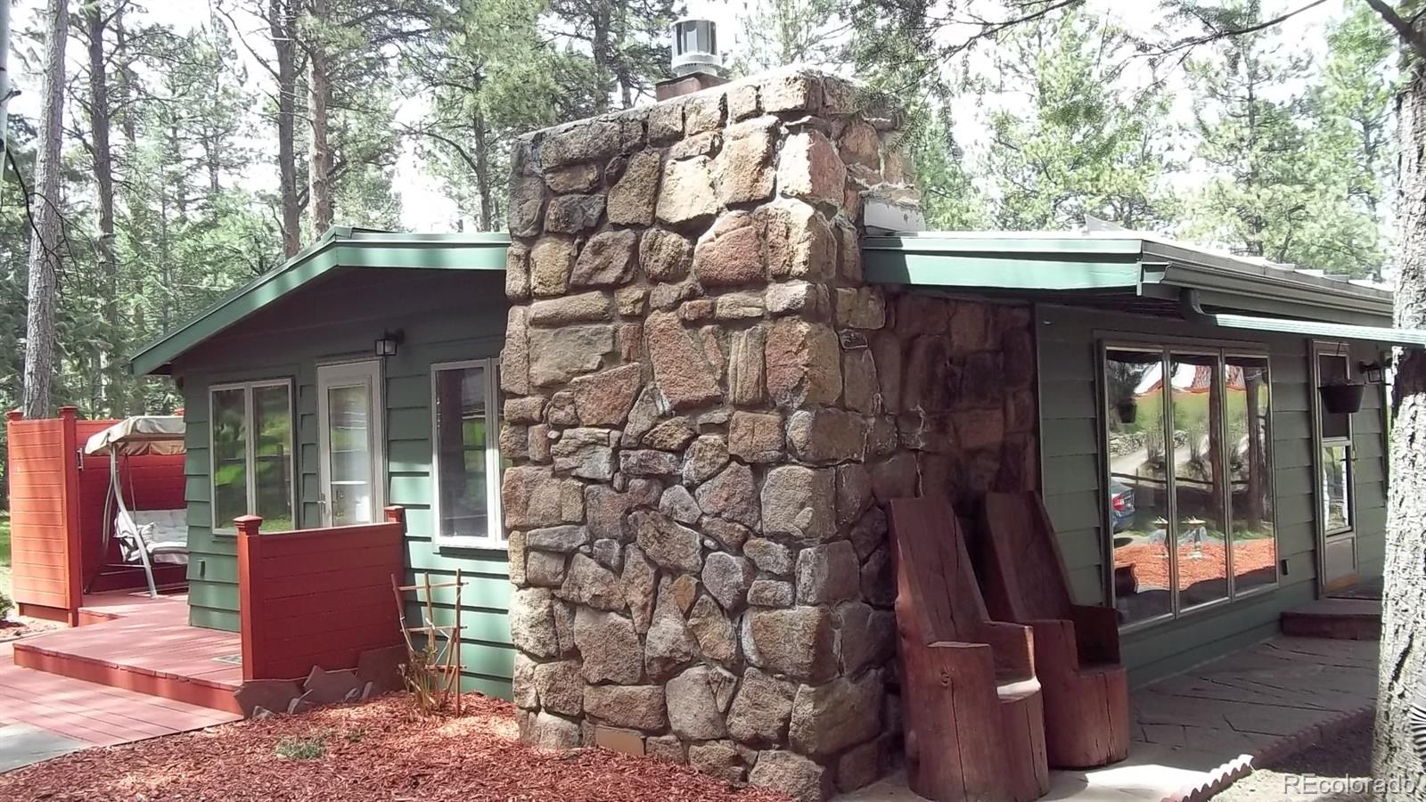 1017 Valley Road Evergreen, CO 80439 - Photo 5 of 17 a front view of a house with garden