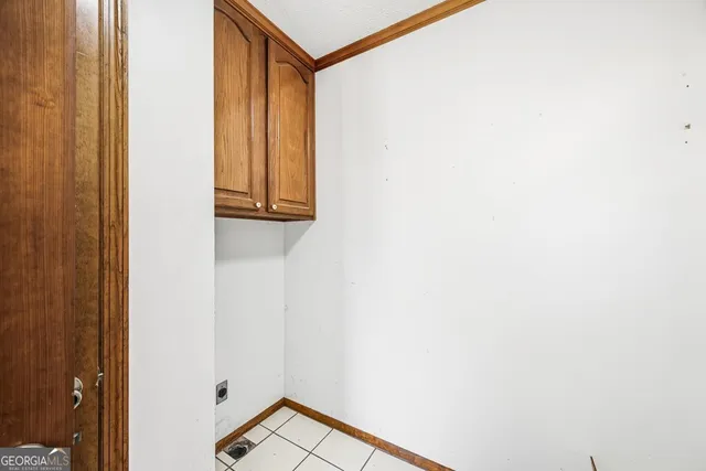 an empty room with a window and a ceiling fan