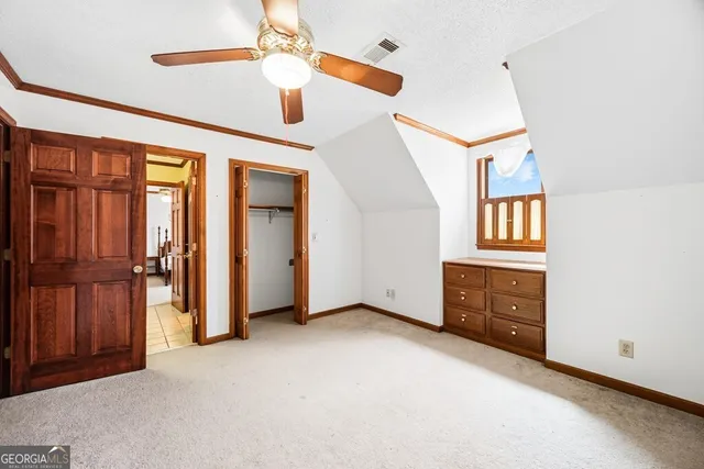 a spacious bathroom with a double vanity sink a mirror and a shower