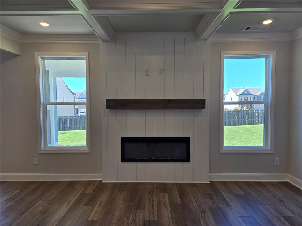 304 Westfall Terrace Loganville, GA 30052 - Photo 12 of 50 a view of an empty room with wooden floor and a window